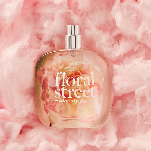 Floral Street Wonderland Peony vegan luxury gourmand perfume bottle on pink cotton candy.